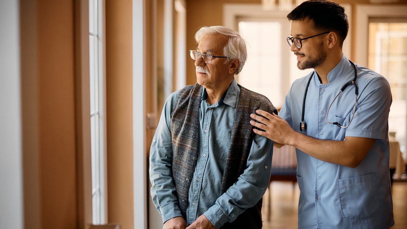A caregiver walking with a resident at Oasis Assisted Care Living